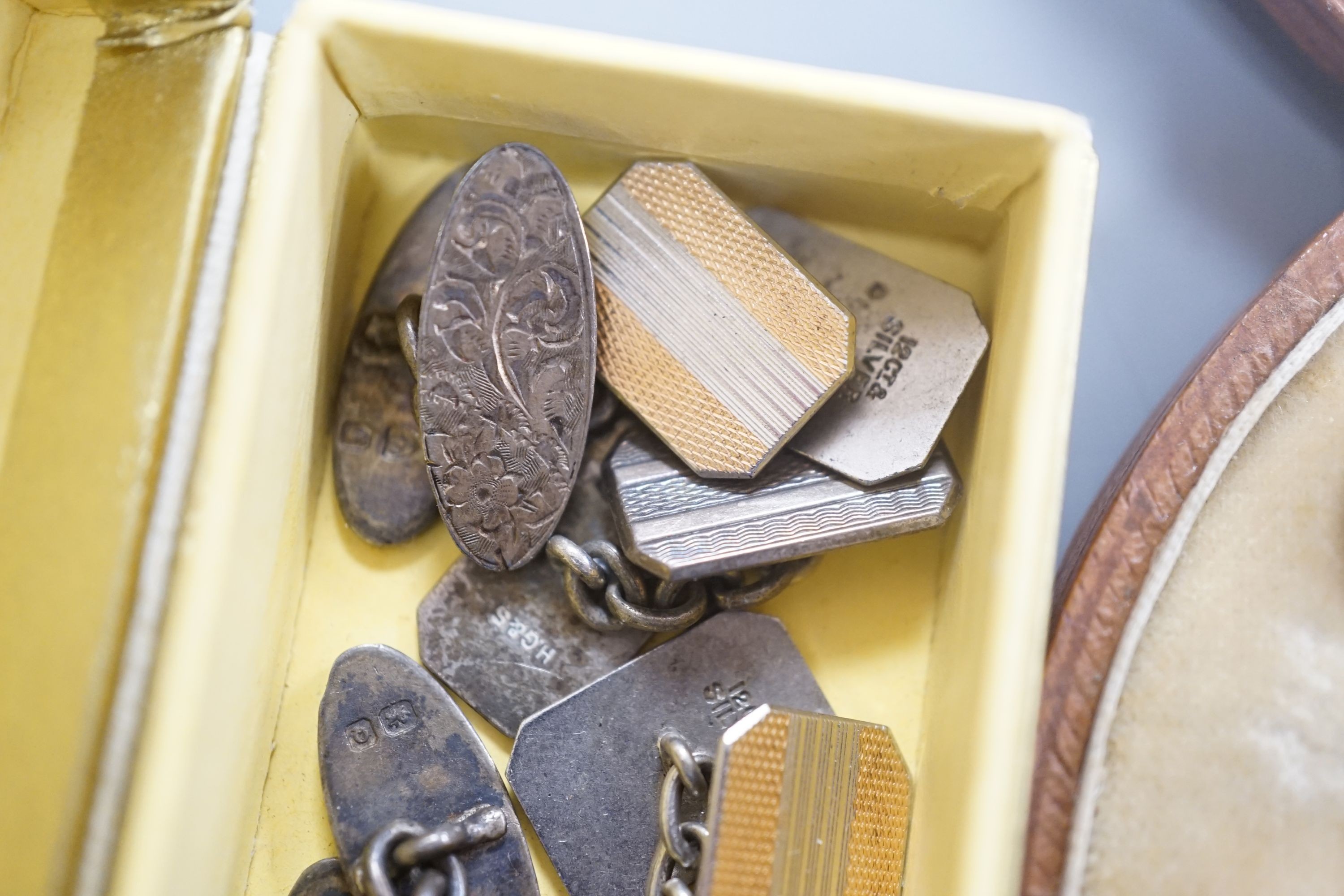 A cased early 20th century six piece gilt metal, mother of pearl and enamel dress stud set and four pairs of silver or white metal cufflinks.